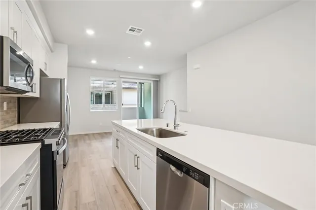 a kitchen that has a sink and a stove