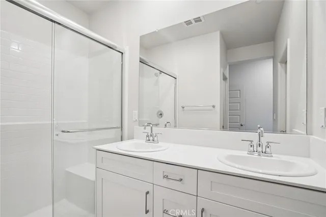 a view of a living room with a large window and kitchen view
