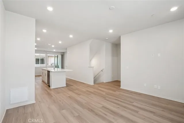 a view of a kitchen with a sink and wooden floor