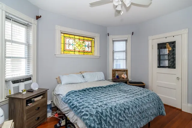 a bedroom with a bed and a window