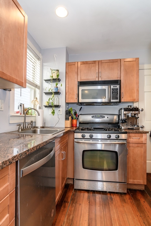 775 Columbia Road, Unit 1 Boston, MA 02125 - Photo 5 of 11 a kitchen with a stove a sink and a microwave