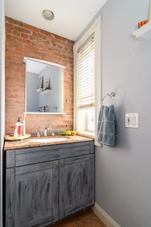 775 Columbia Road, Unit 1 Boston, MA 02125 - Photo 7 of 11 a bathroom with a sink and a mirror