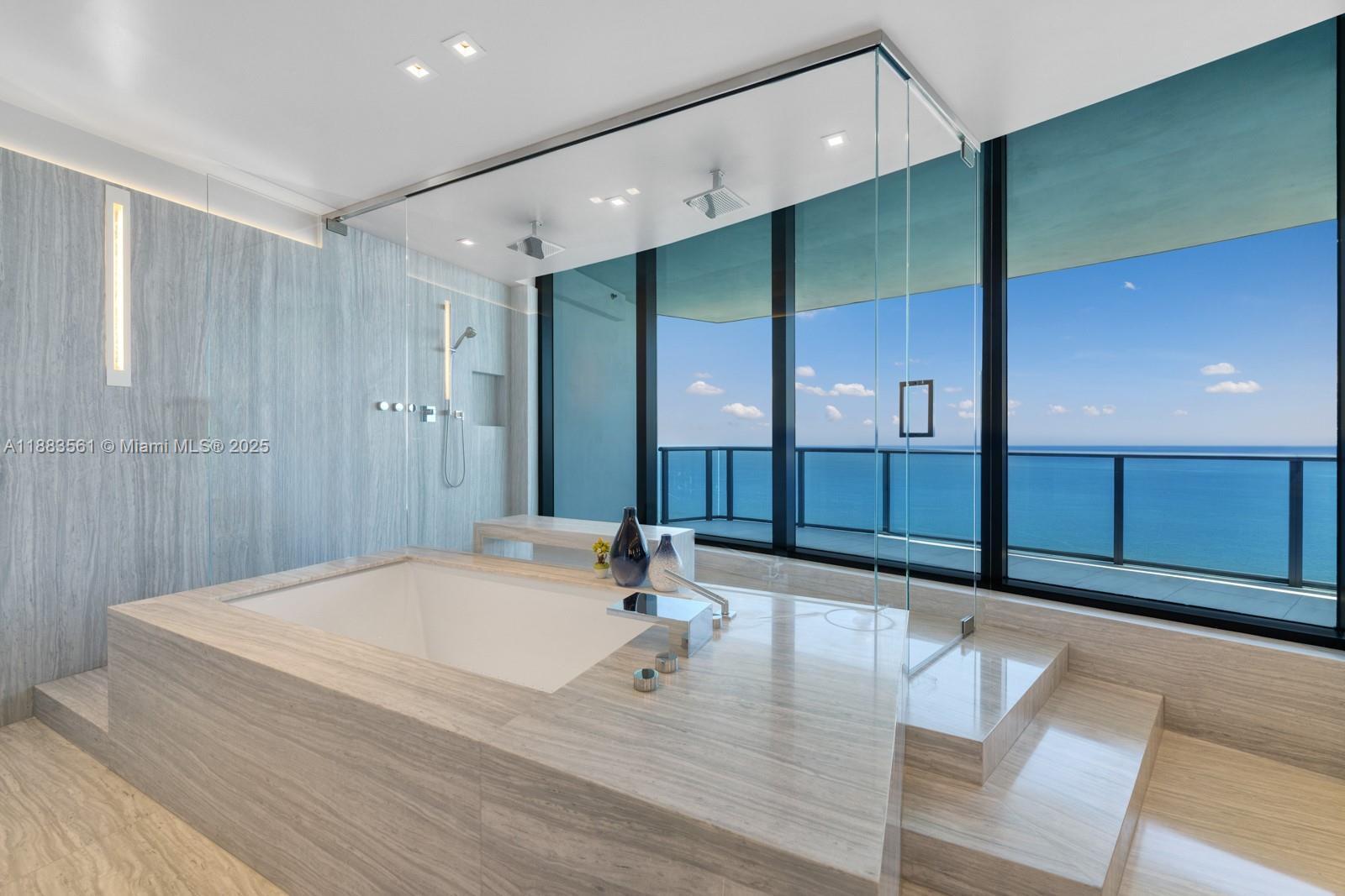 18555 Collins Avenue, Unit PH1 Sunny Isles Beach, FL 33160 - Photo 13 of 32 a bathroom with a sink and a mirror