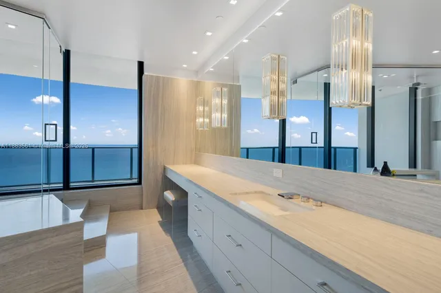 a spacious bathroom with a granite countertop sink mirror and shower