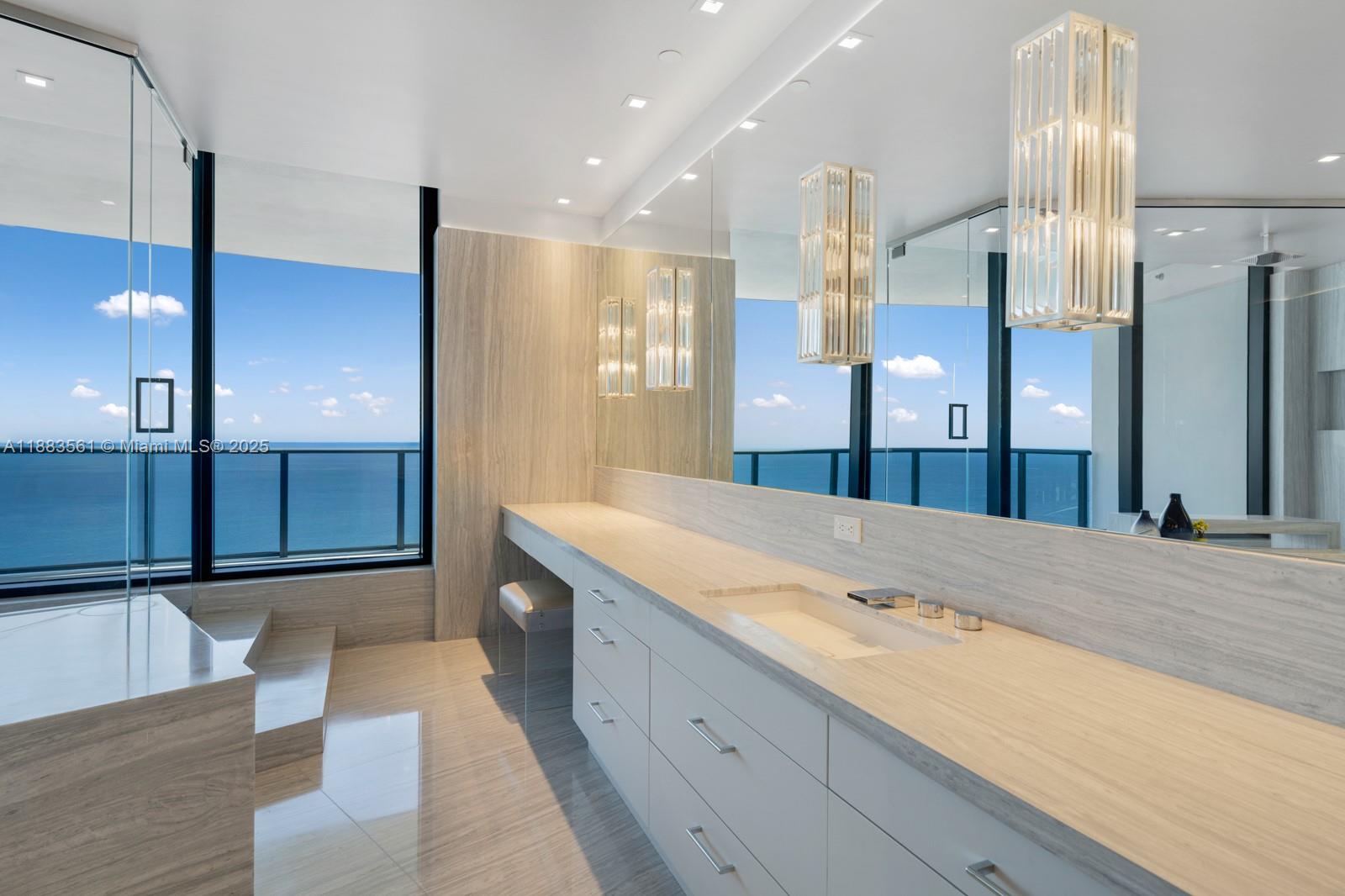 18555 Collins Avenue, Unit PH1 Sunny Isles Beach, FL 33160 - Photo 14 of 32 a spacious bathroom with a granite countertop sink mirror and shower