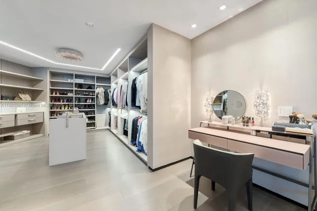 a dining hall with stainless steel appliances kitchen island granite countertop a sink and cabinets