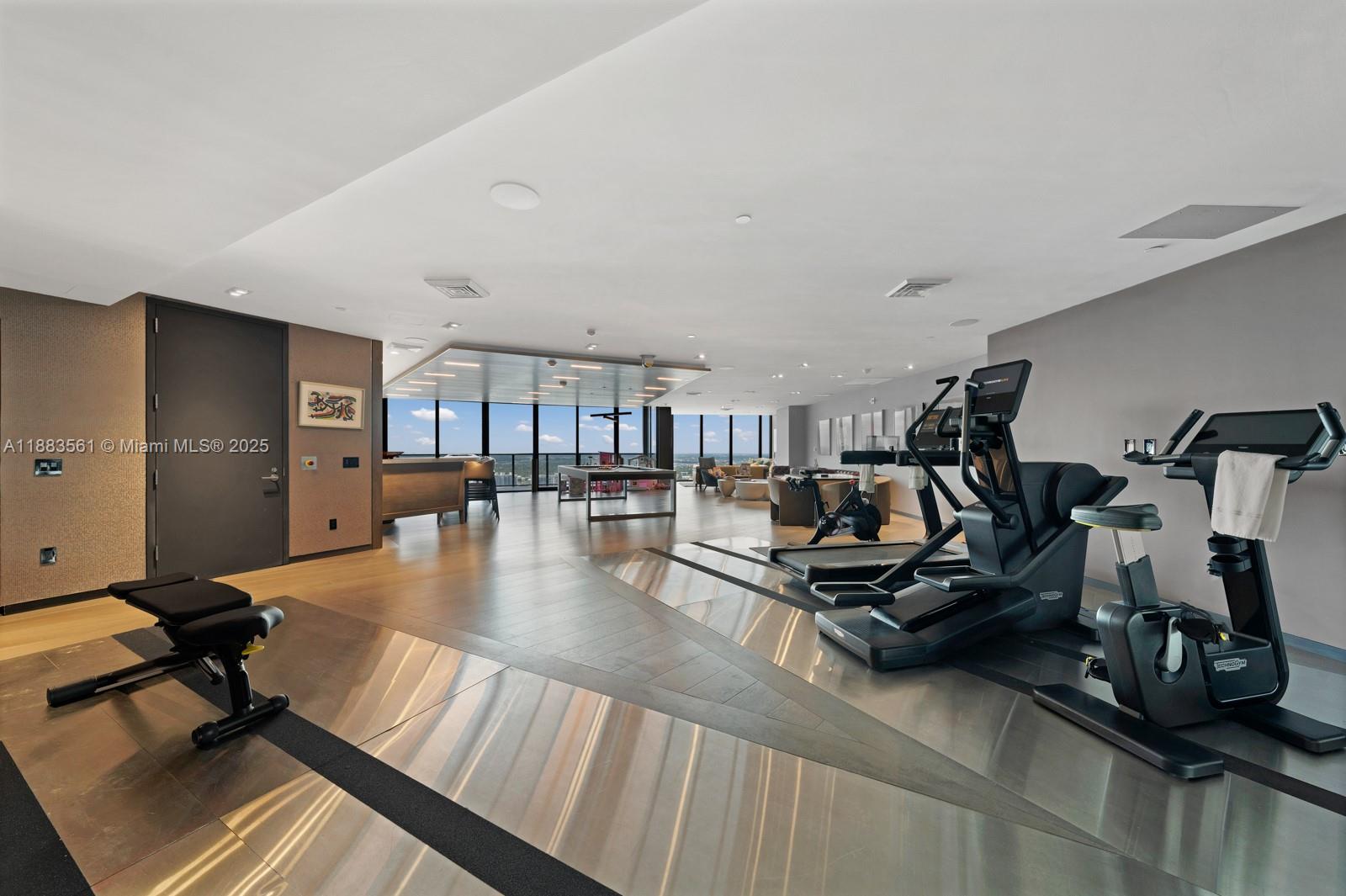 18555 Collins Avenue, Unit PH1 Sunny Isles Beach, FL 33160 - Photo 18 of 32 a view of a room with gym equipment
