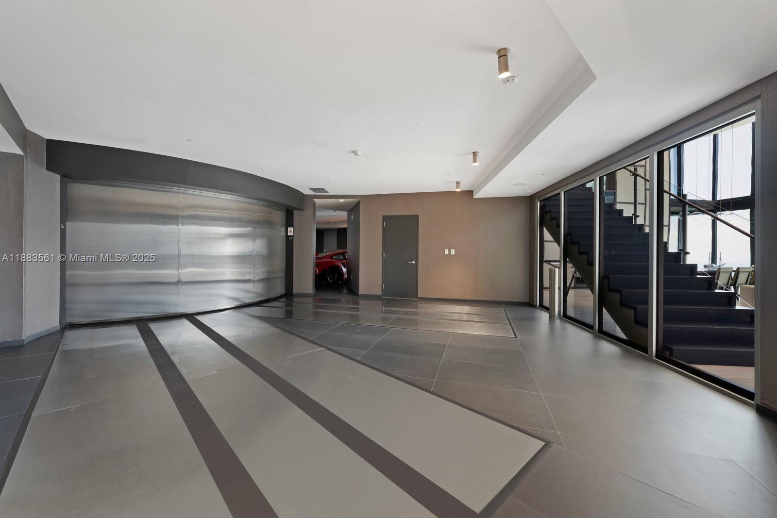 18555 Collins Avenue, Unit PH1 Sunny Isles Beach, FL 33160 - Photo 19 of 32 a view of an empty room with wooden floor