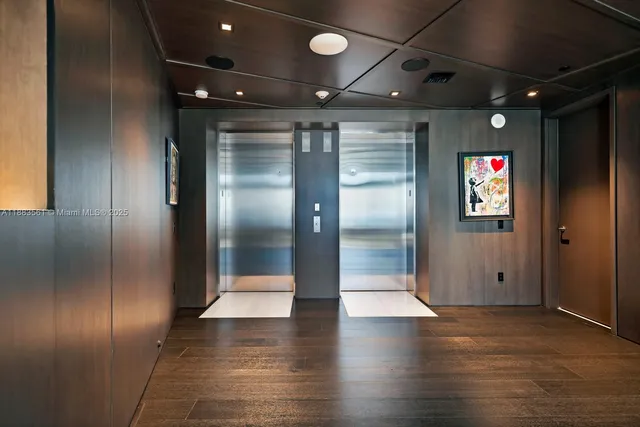 a view of water heater room with wooden floor