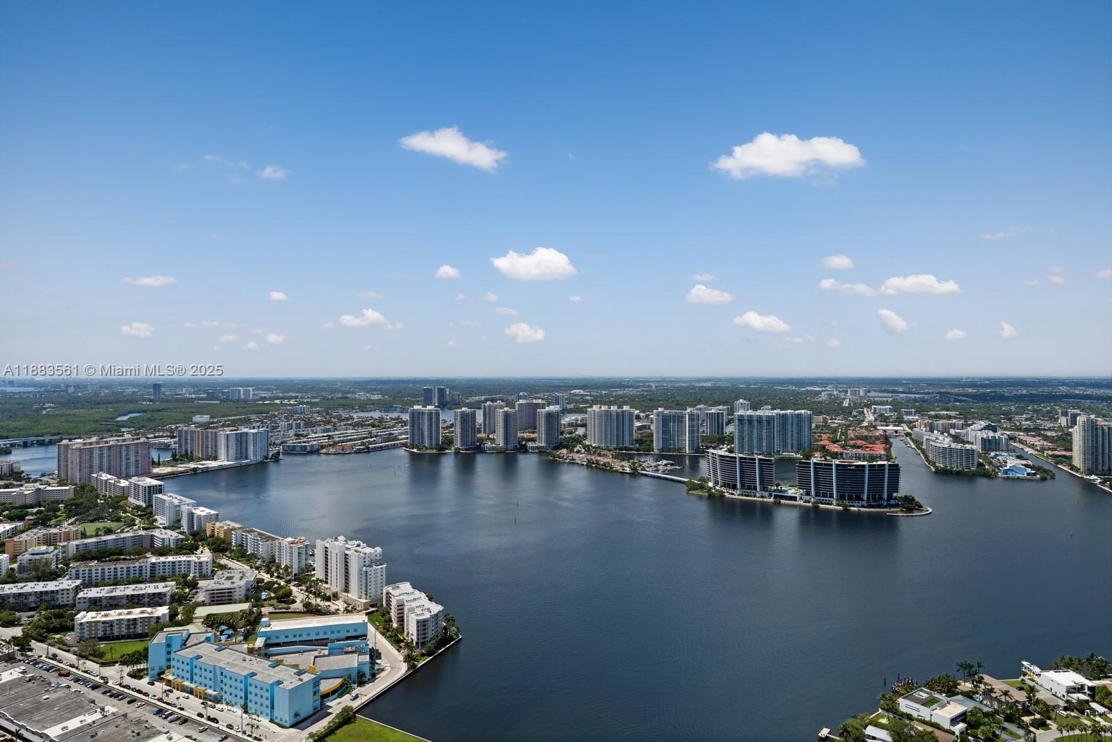 18555 Collins Avenue, Unit PH1 Sunny Isles Beach, FL 33160 - Photo 22 of 32 a view of a ocean with boats and trees
