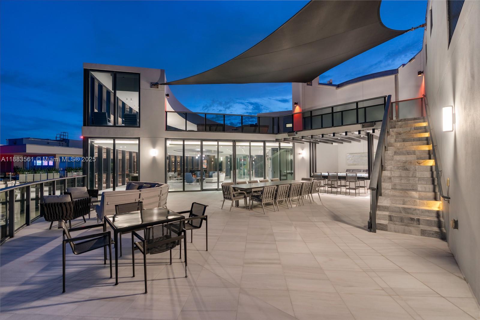 18555 Collins Avenue, Unit PH1 Sunny Isles Beach, FL 33160 - Photo 24 of 32 a view of a dinning tables and chairs in a patio