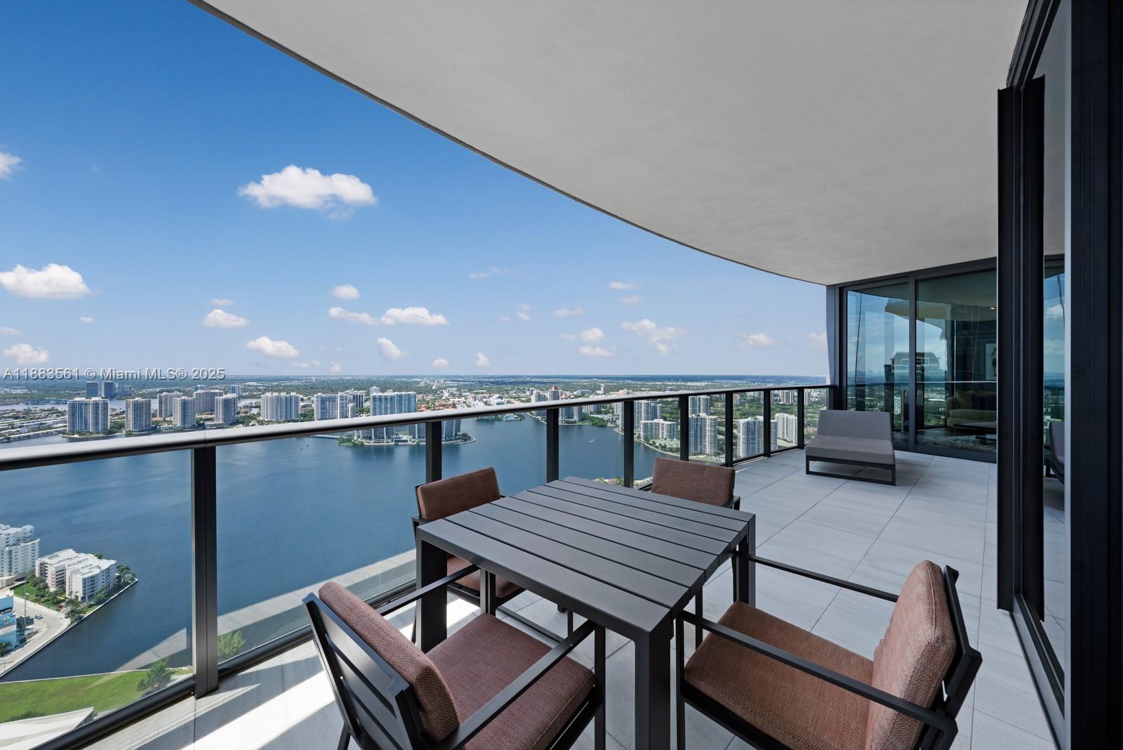 18555 Collins Avenue, Unit PH1 Sunny Isles Beach, FL 33160 - Photo 25 of 32 a terrace with outdoor seating and city view
