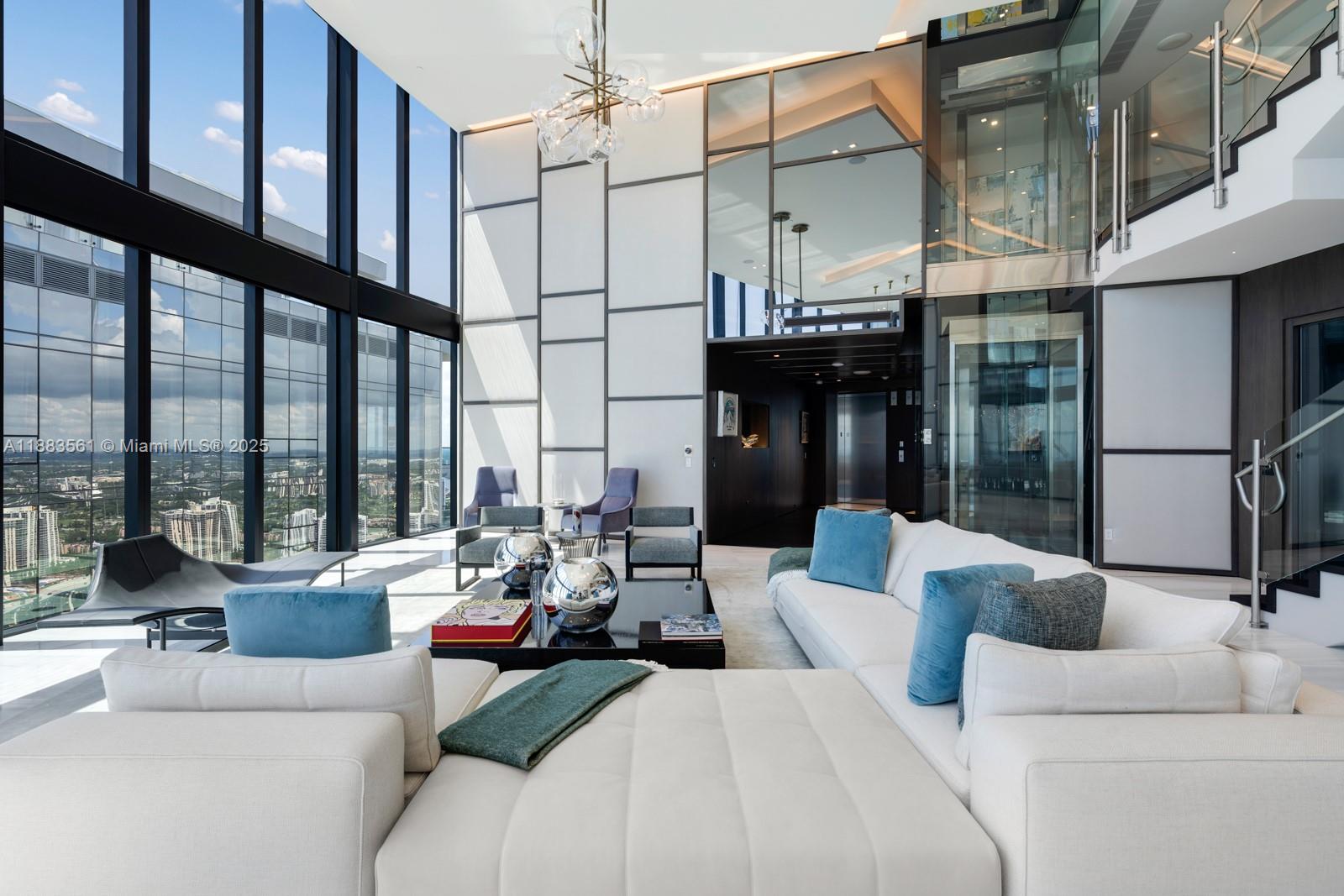 18555 Collins Avenue, Unit PH1 Sunny Isles Beach, FL 33160 - Photo 3 of 32 a living room with furniture and large windows