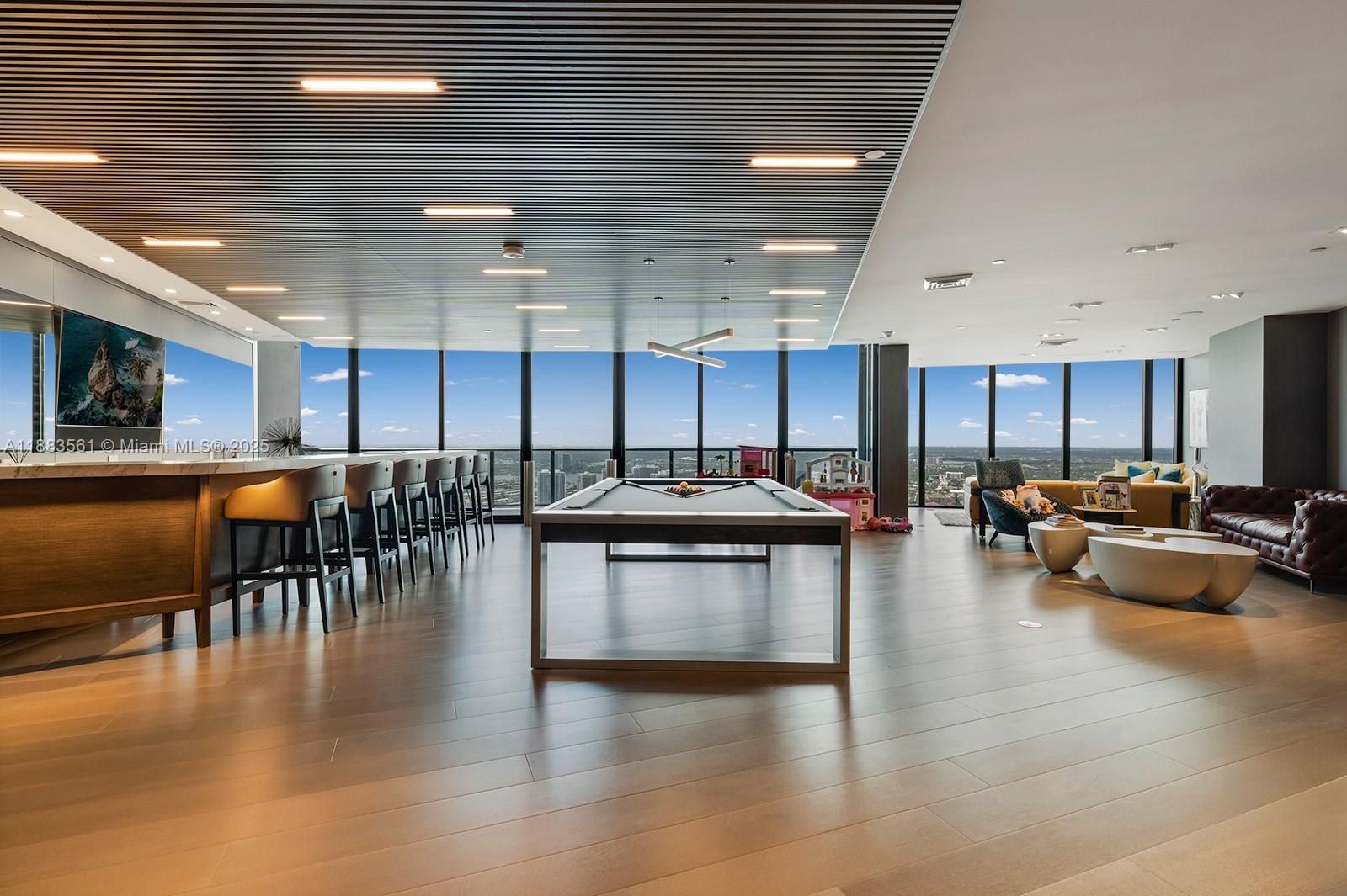 18555 Collins Avenue, Unit PH1 Sunny Isles Beach, FL 33160 - Photo 6 of 32 a kitchen with lots of counter top space and living room