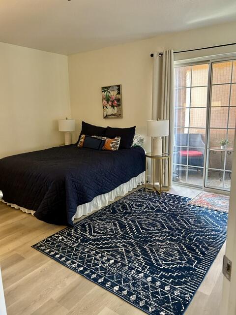 2700 Lawrence Crossley Road, Unit 18 Palm Springs, CA 92264 - Photo 4 of 7 a bedroom with a bed and a chair