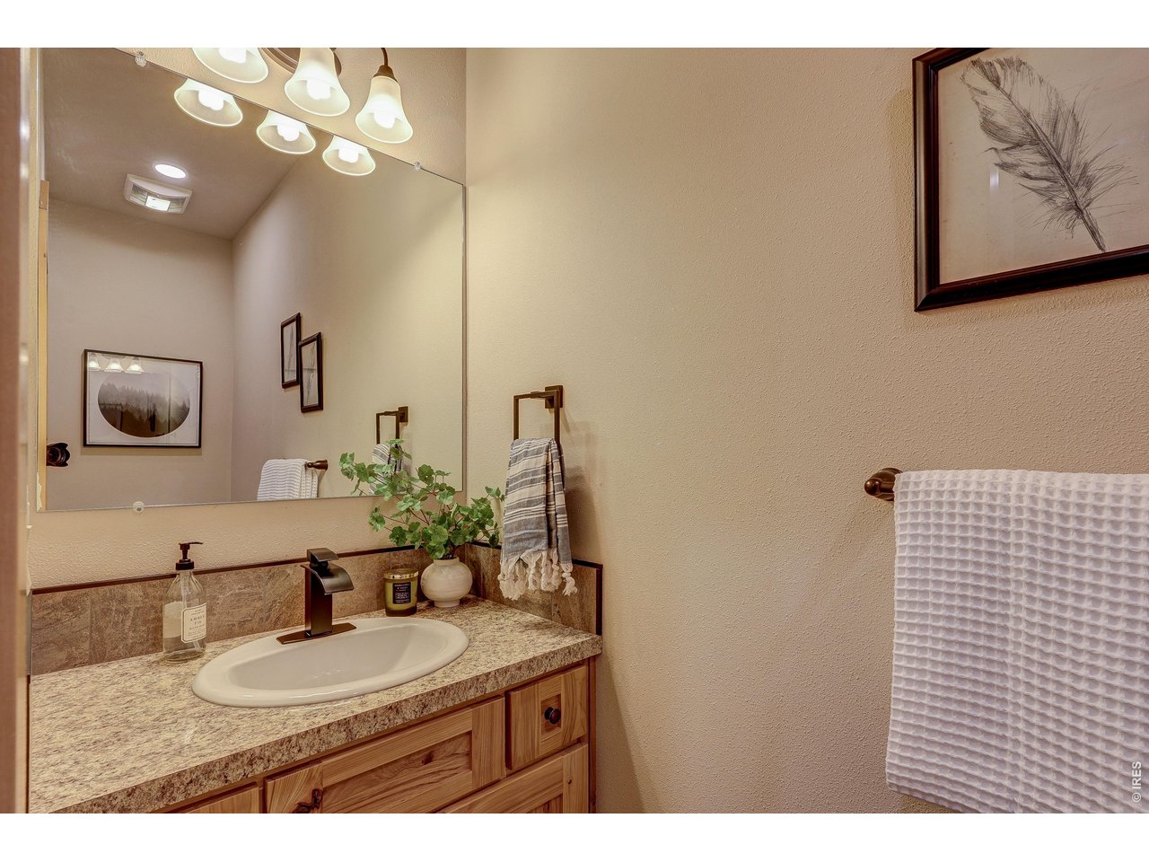 18298 Romar Ranch Road Carr, CO 80612 - Photo 13 of 49 a bathroom with a granite countertop sink and a mirror