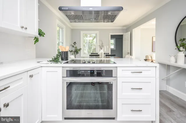a view of a kitchen with a stove and a sink