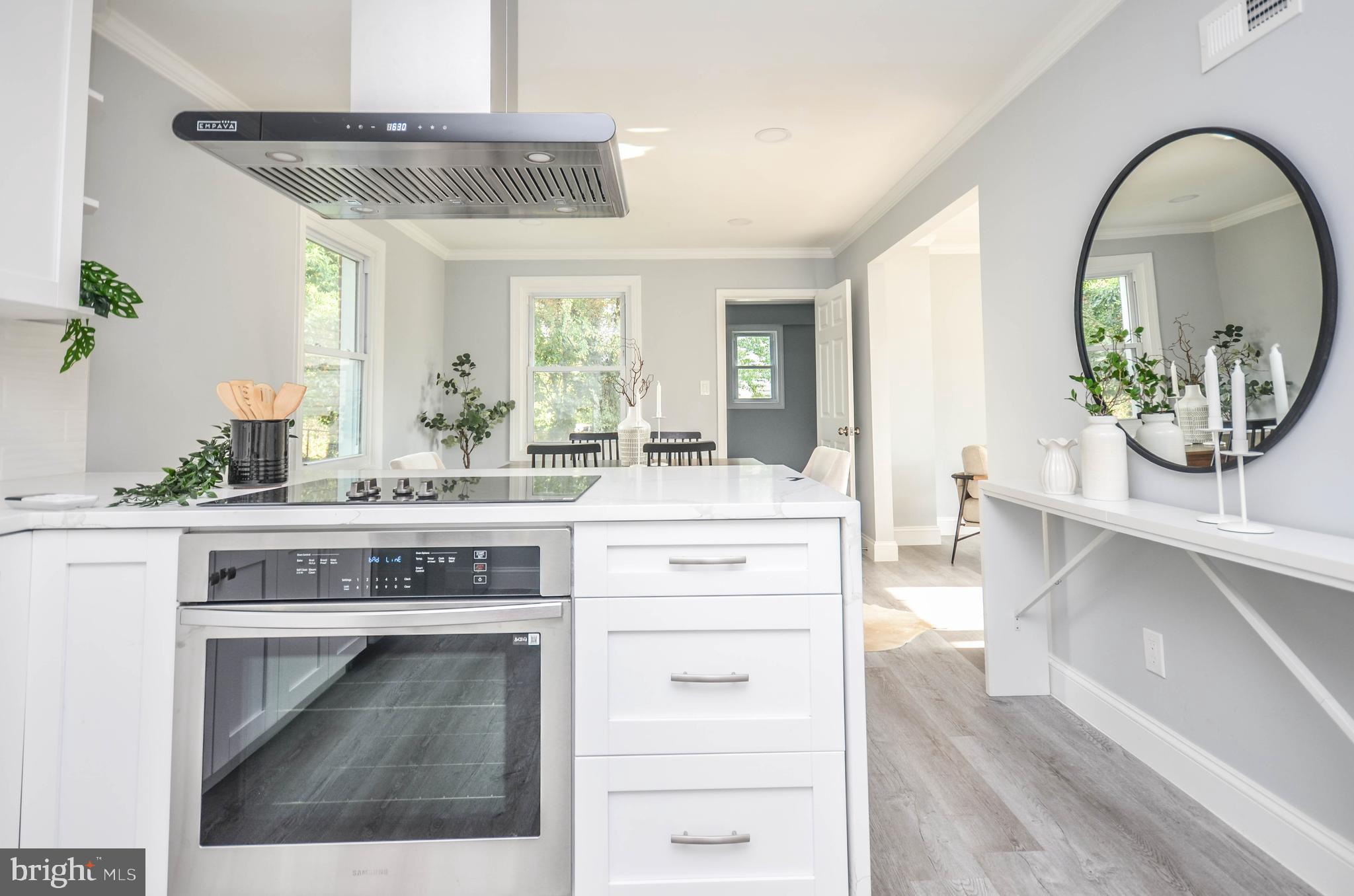 7009 Adelphi Road Hyattsville, MD 20782 - Photo 12 of 41 a kitchen with a stove and a white cabinets