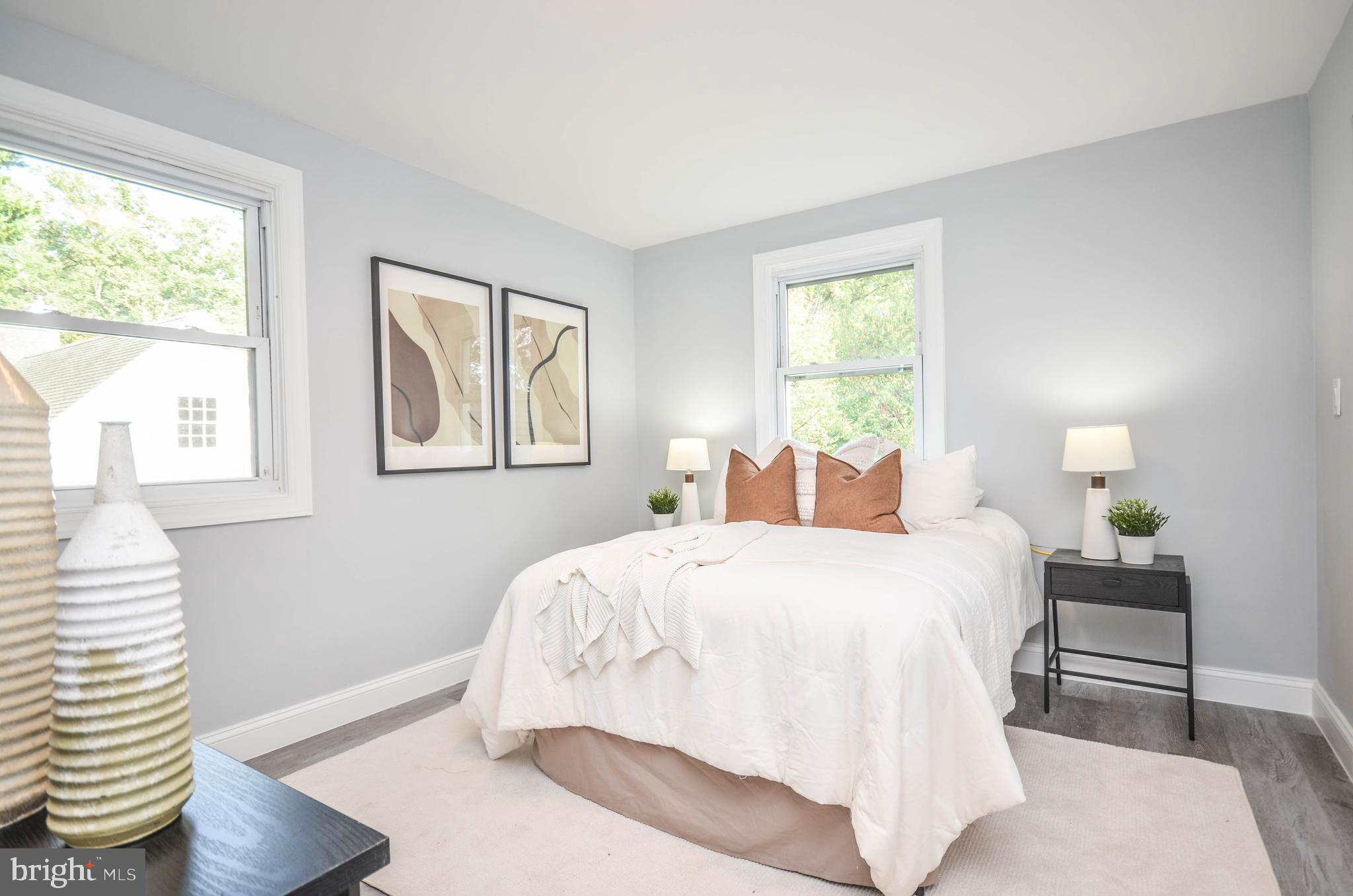 7009 Adelphi Road Hyattsville, MD 20782 - Photo 16 of 41 a bedroom with a bed and wooden floor