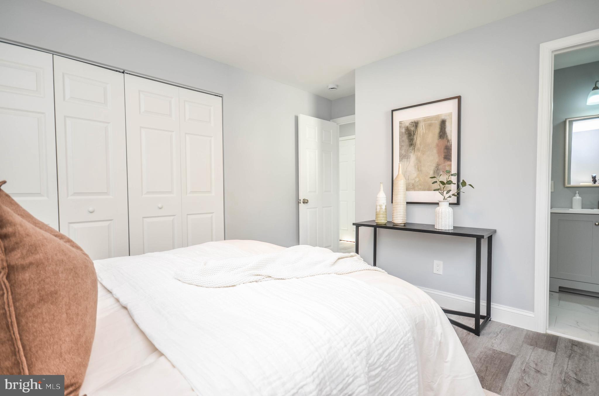 7009 Adelphi Road Hyattsville, MD 20782 - Photo 17 of 41 a bedroom with a bed and a table