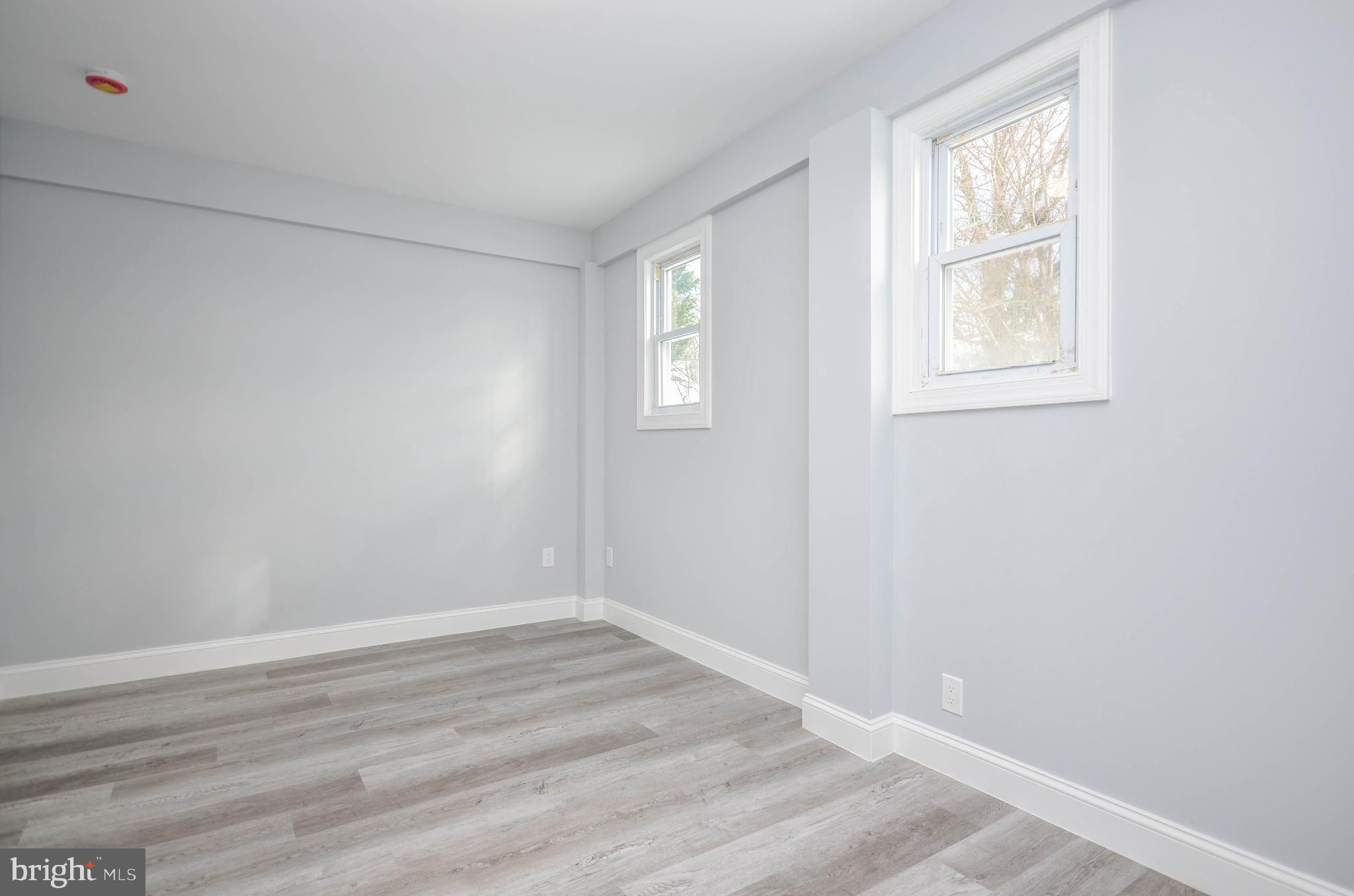 7009 Adelphi Road Hyattsville, MD 20782 - Photo 20 of 41 a view of an empty room with wooden floor and a window