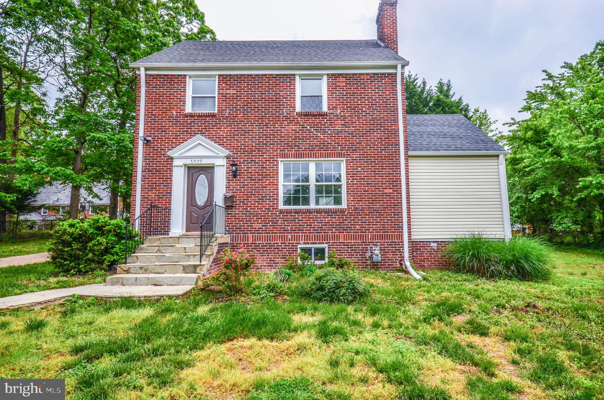 7009 Adelphi Road Hyattsville, MD 20782 - Photo 2 of 41 a front view of a house with a garden