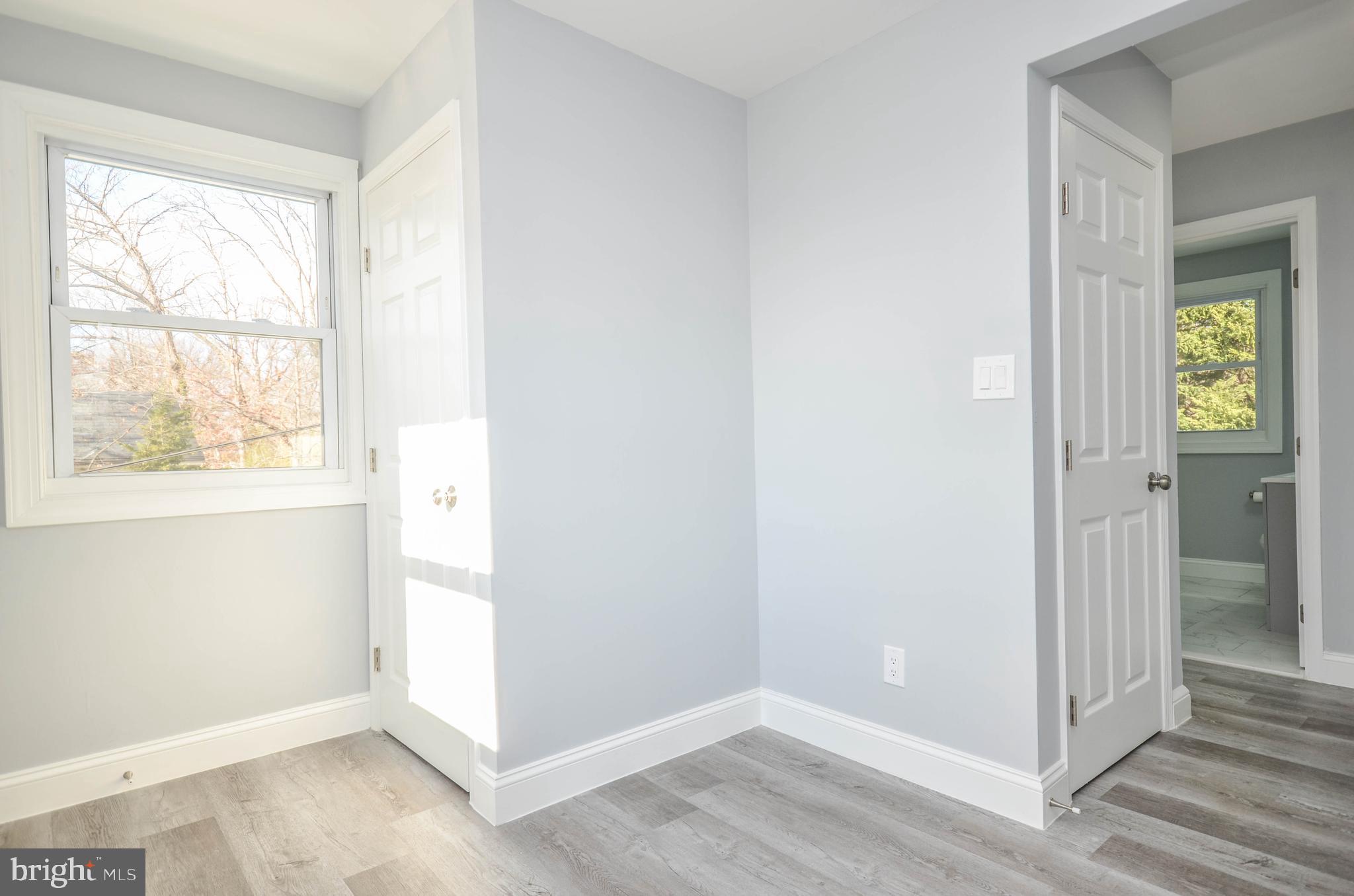 7009 Adelphi Road Hyattsville, MD 20782 - Photo 24 of 41 a view of an empty room with wooden floor and a window