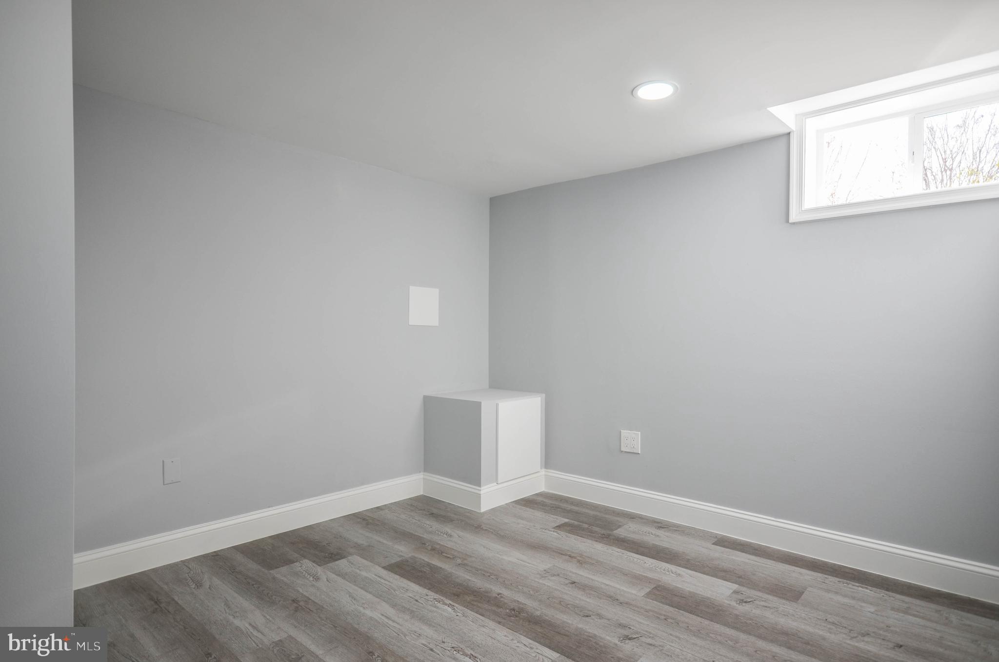 7009 Adelphi Road Hyattsville, MD 20782 - Photo 33 of 41 an empty room with wooden floor and windows