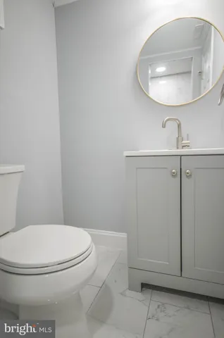 a white toilet sitting next to a bathroom sink