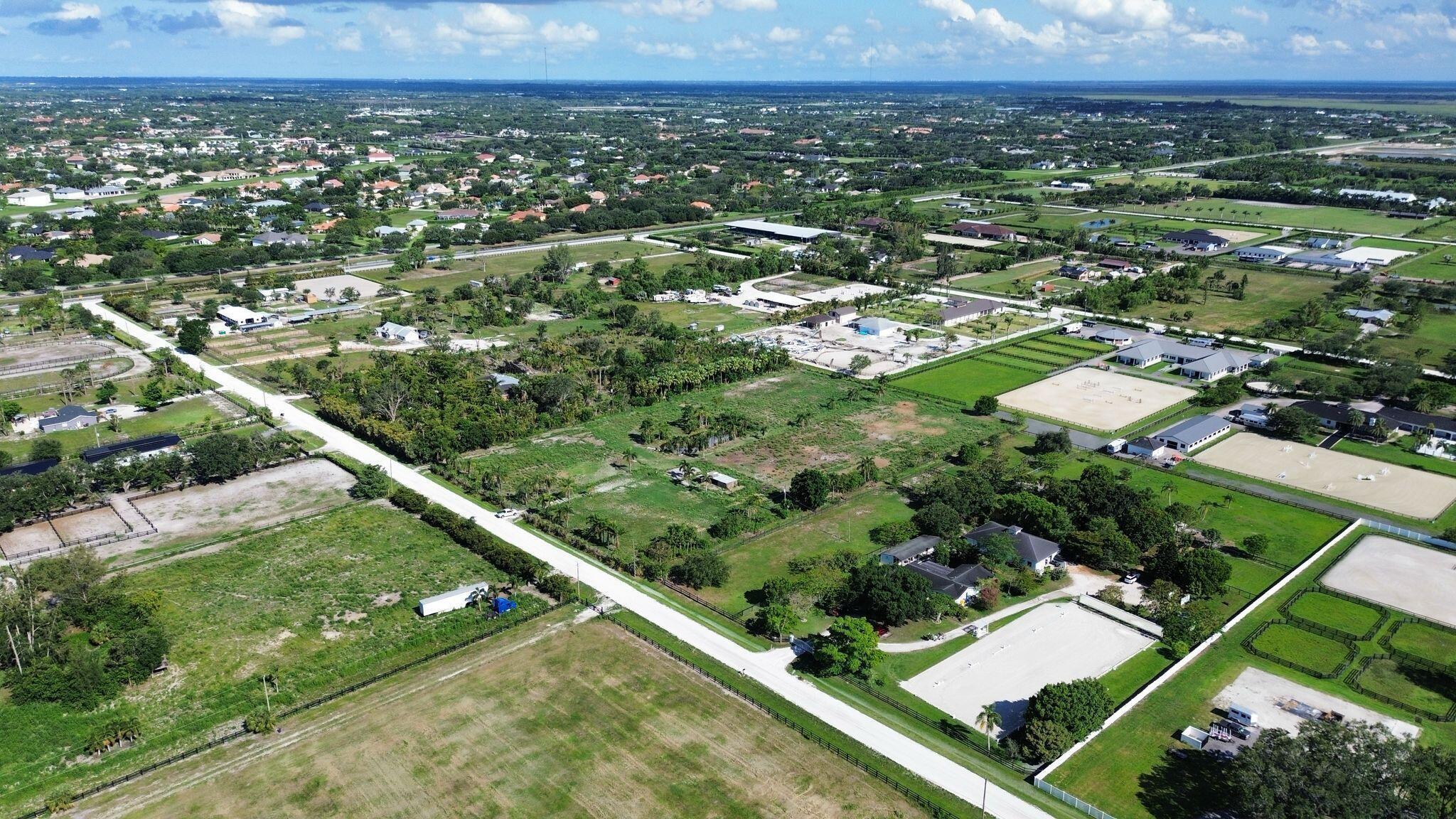 16290 Rustic Road Wellington, FL 33470 - Photo 9 of 20 an aerial view of residential houses with outdoor space and trees