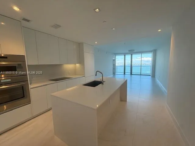 an outdoor sitting area with furniture and umbrella