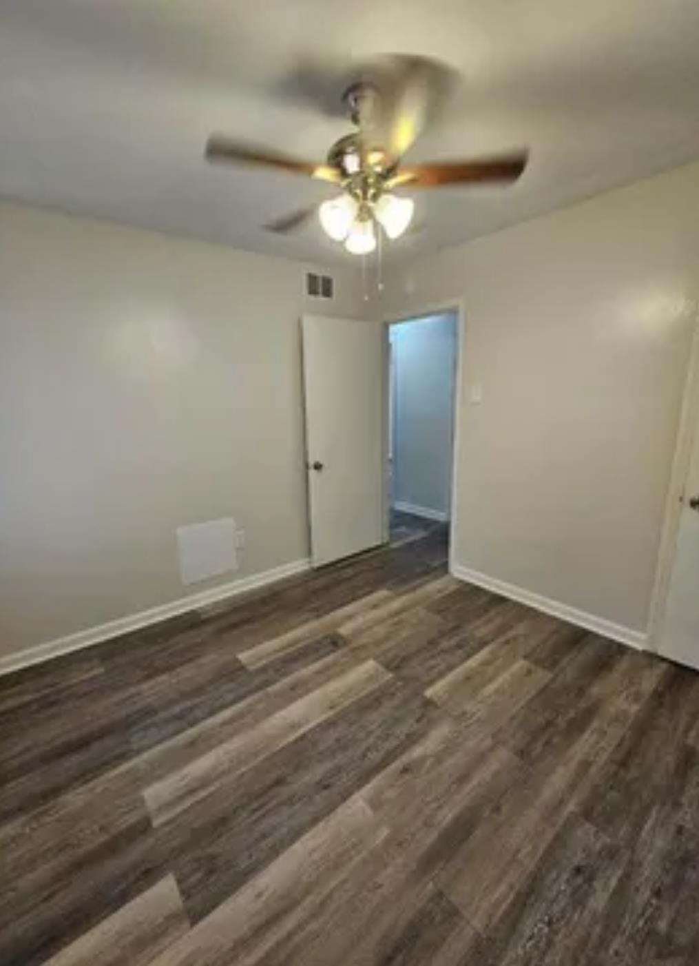 3497 Brantley Road Memphis, TN 38109 - Photo 6 of 10 Unfurnished bedroom with a ceiling fan, dark wood-style flooring, visible vents, and baseboards