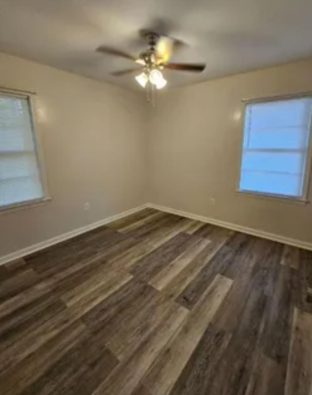 3497 Brantley Road Memphis, TN 38109 - Photo 8 of 10 Spare room featuring a ceiling fan, baseboards, and dark wood-type flooring