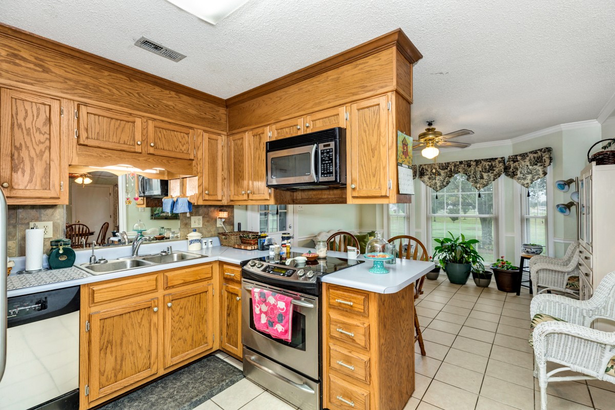 27404 Cedar Hill Road Ardmore, AL 35739 - Photo 11 of 32 a kitchen with sink cabinets and stove top oven