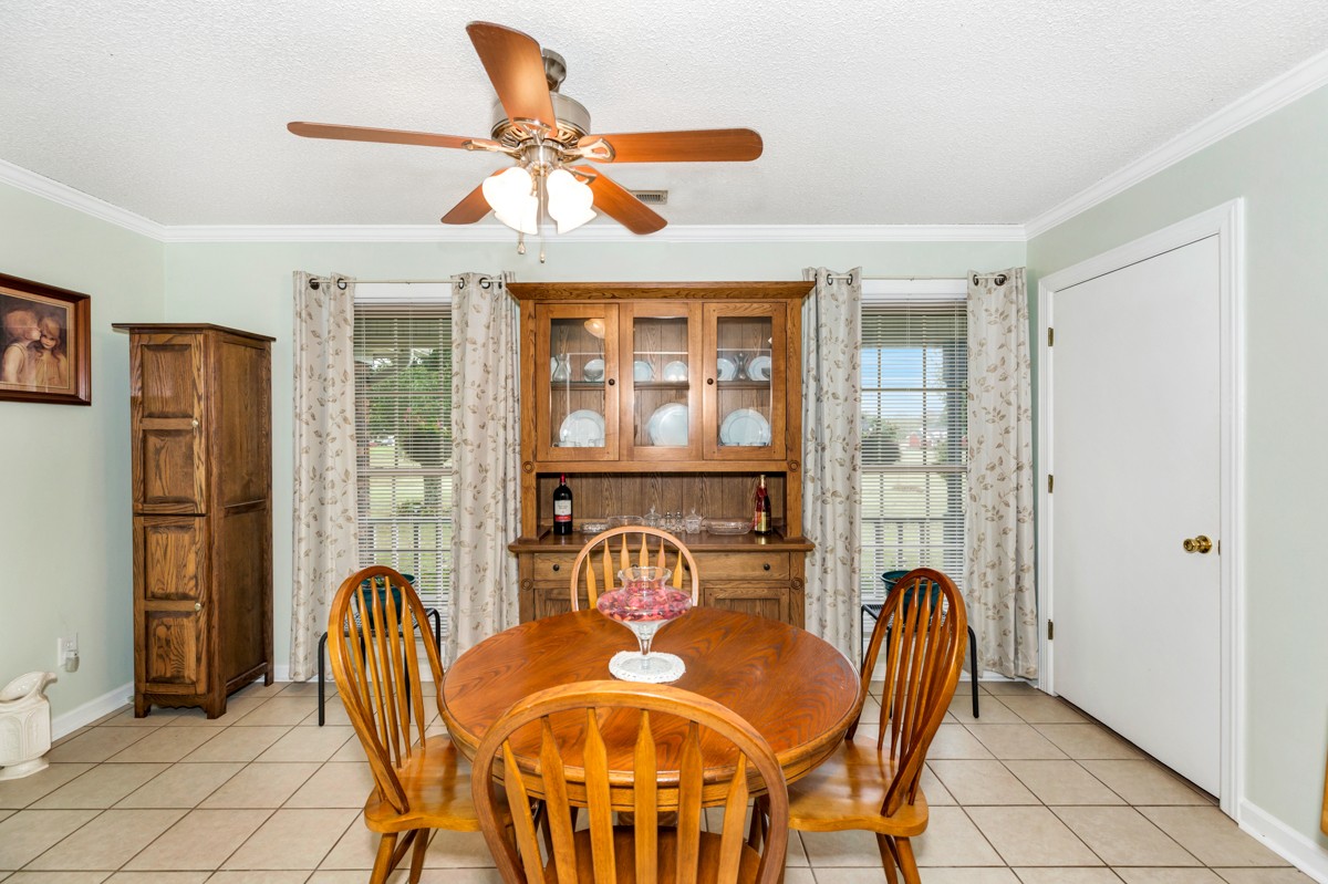 27404 Cedar Hill Road Ardmore, AL 35739 - Photo 15 of 32 a view of a dining room with furniture and a chandelier