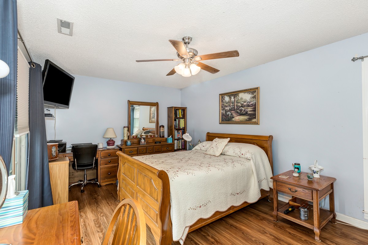 27404 Cedar Hill Road Ardmore, AL 35739 - Photo 16 of 32 a bed room with a bed a television and furniture