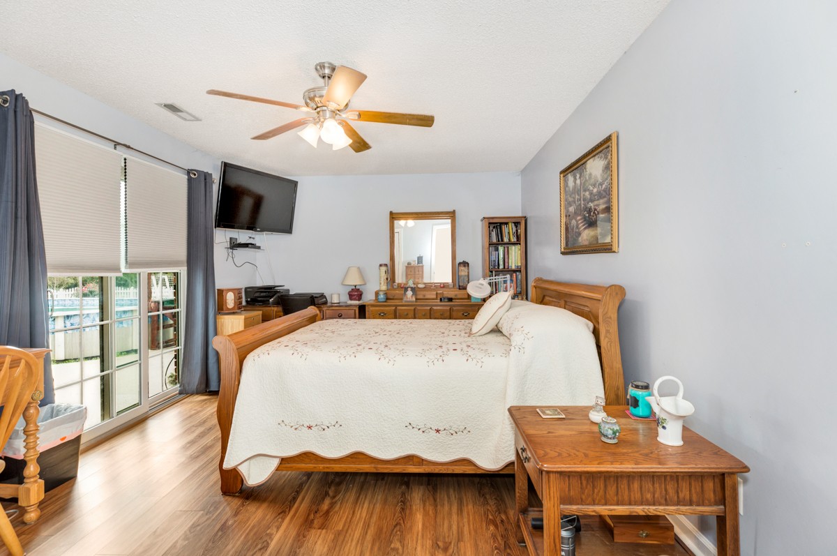 27404 Cedar Hill Road Ardmore, AL 35739 - Photo 17 of 32 a bedroom with a bed and wooden floor