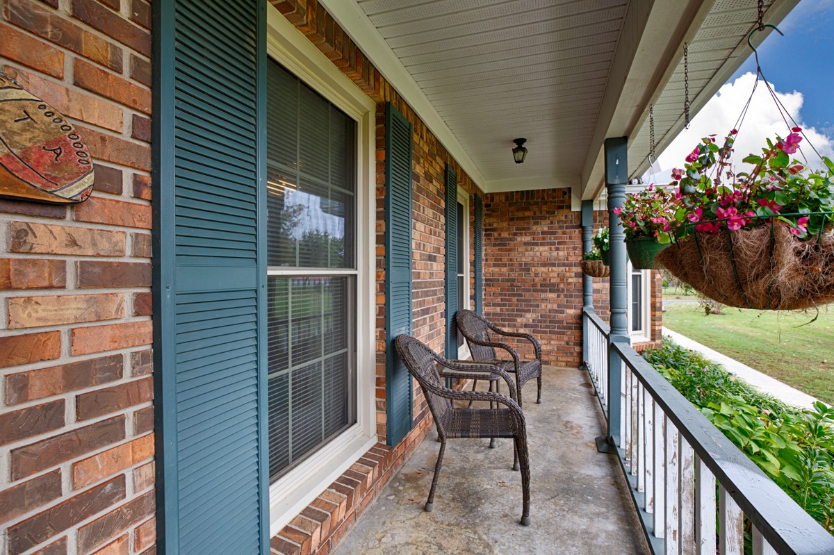 27404 Cedar Hill Road Ardmore, AL 35739 - Photo 4 of 32 a view of a porch with furniture and a potted plant