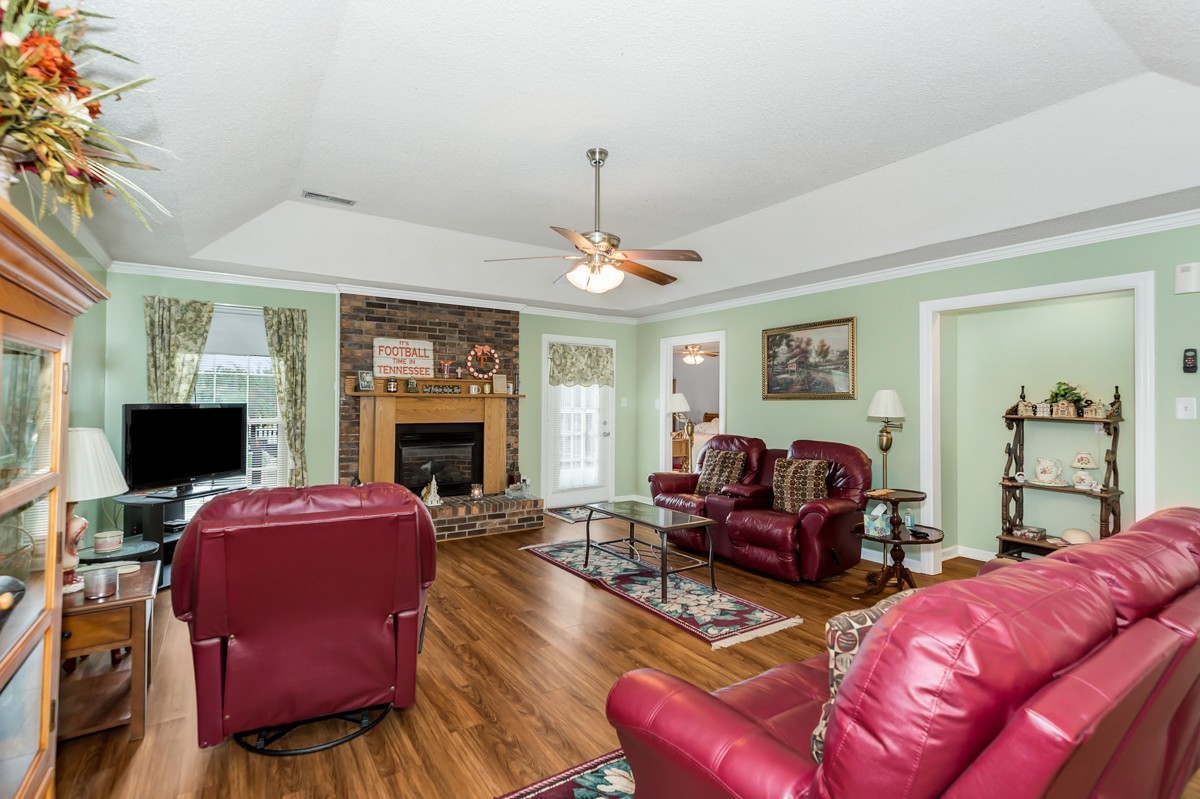 27404 Cedar Hill Road Ardmore, AL 35739 - Photo 6 of 32 a living room with furniture a flat screen tv and a fireplace