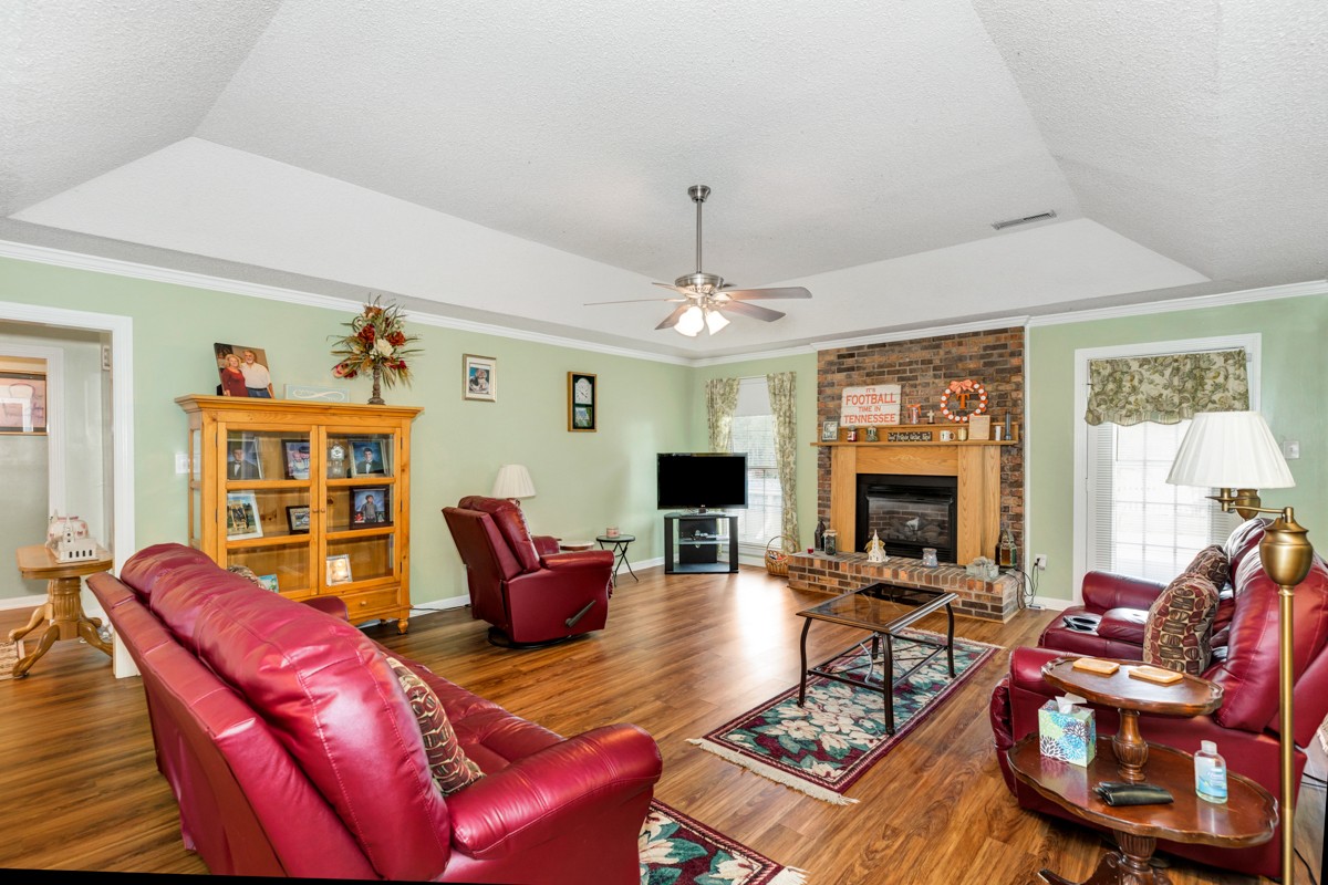 27404 Cedar Hill Road Ardmore, AL 35739 - Photo 7 of 32 a living room with furniture a fireplace and a window