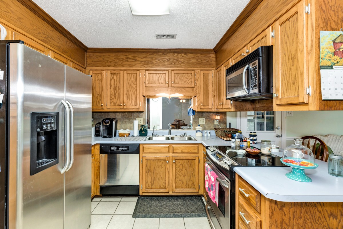 27404 Cedar Hill Road Ardmore, AL 35739 - Photo 9 of 32 a kitchen with a sink cabinets and window