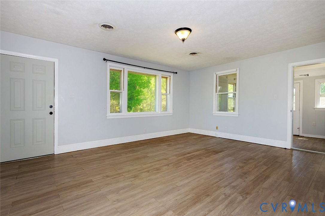 9903 Boze Road Ford, VA 23850 - Photo 4 of 45 an empty room with wooden floor and windows