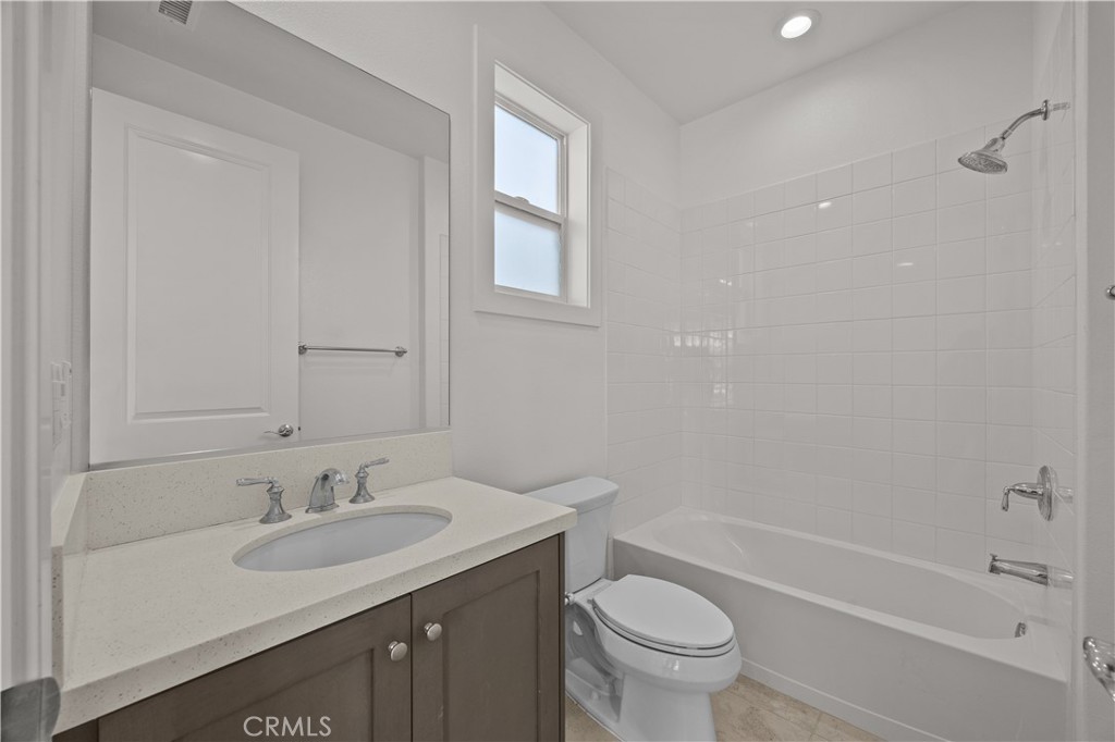 20638 Deer Grass Court Porter Ranch, CA 91326 - Photo 36 of 50 a bathroom with a granite countertop sink a toilet and a bathtub