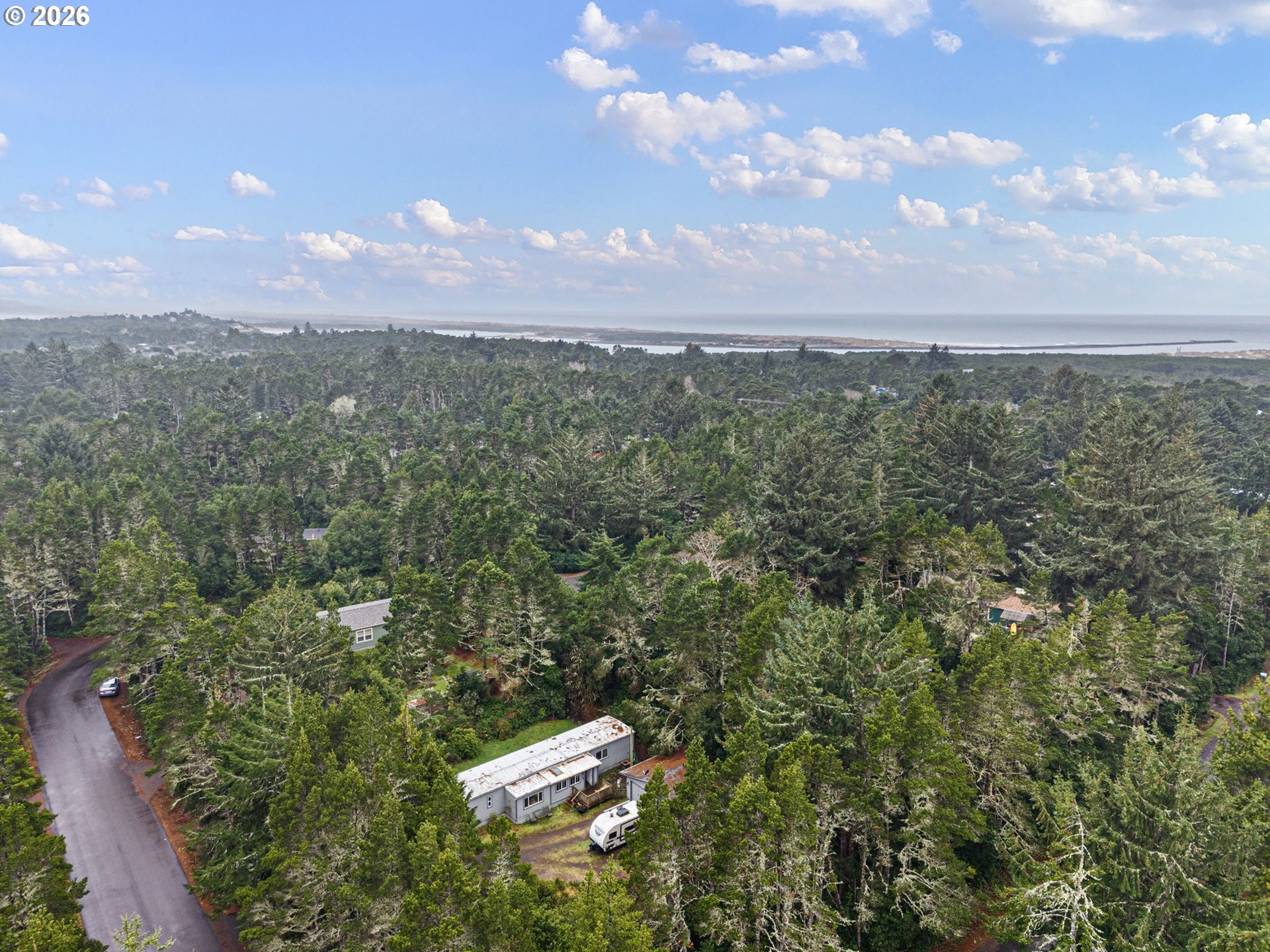 4826 Rhododendron Loop Florence, OR 97439 - Photo 39 of 41 a view of a city with lush green forest