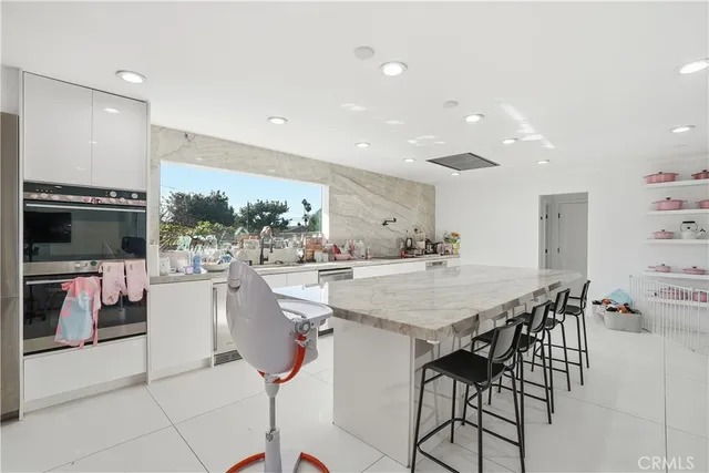 a swimming pool with an outdoor space and seating