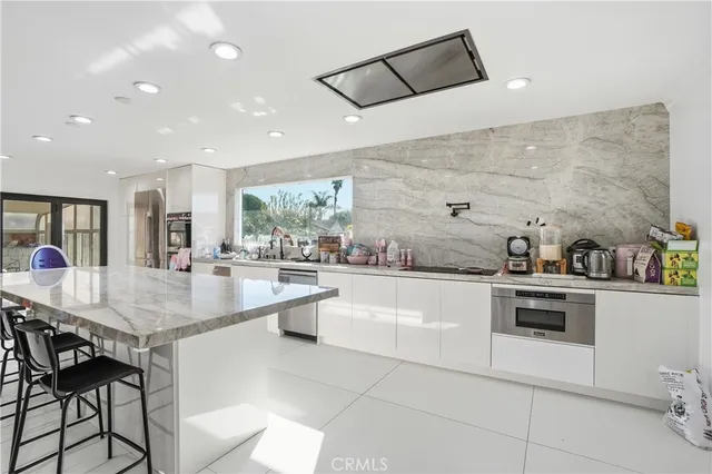 a view of kitchen with refrigerator and window