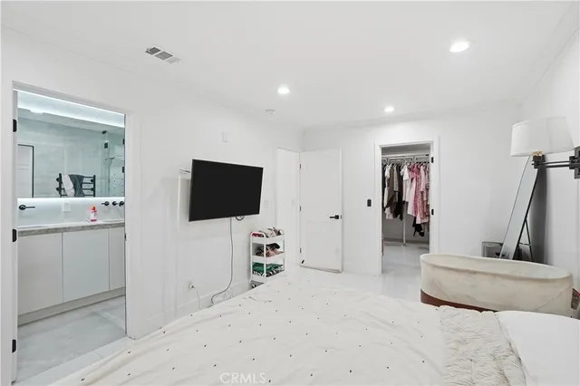 a bedroom with a bed and a chair