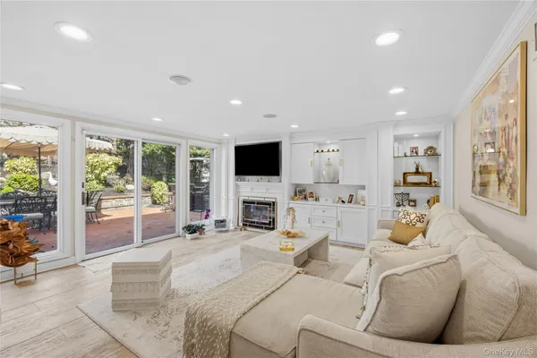 a living room with fireplace furniture and a flat screen tv