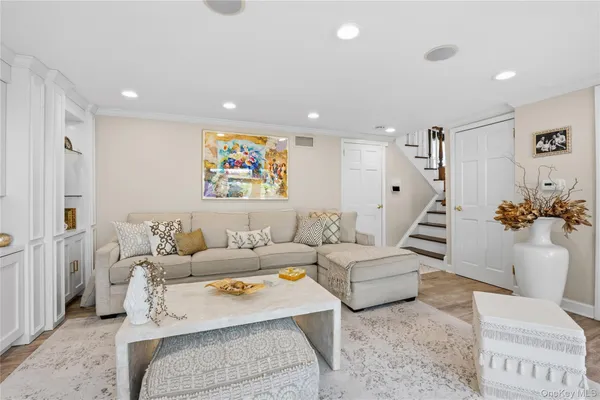 a living room with furniture and a painting