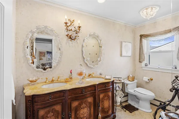 a bathroom with a granite countertop toilet sink and mirror
